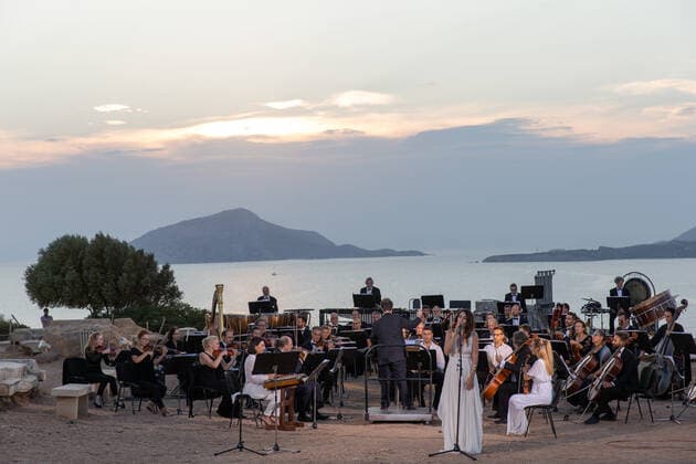 (200917) -- ATHENS, Sept. 17, 2020 -- Musicians perform a musical in front of the ruins of the Temple of Poseidon at cape Sounion, some 70 km southeast of Athens, Greece, on Sept. 17, 2020. On the occasion of the 70th anniversary of the establishment of the Greek National Tourism Organization (GNTO) and the 71st anniversary of the founding of the People s Republic of China and the Mid-Autumn festival, a musical entitled As long as there shall be Achaeans -- Variations on a Sunbeam was staged on Thursday in front of the ruins of the emblematic 2,500-year-old Temple of Poseidon, the god of the sea in Greek mythology. ) GREECE-CAPE SOUNION-MUSICAL-SINO-GREEK FRIENDSHIP MariosxLolos 
