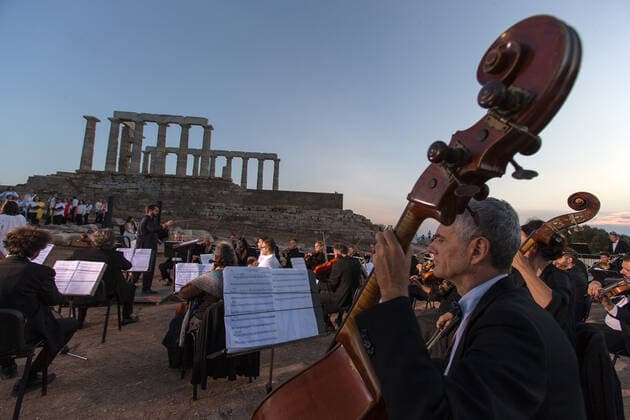 (200917) -- ATHENS, Sept. 17, 2020 -- Musicians perform a musical in front of the ruins of the Temple of Poseidon at cape Sounion, some 70 km southeast of Athens, Greece, on Sept. 17, 2020. On the occasion of the 70th anniversary of the establishment of the Greek National Tourism Organization (GNTO) and the 71st anniversary of the founding of the People s Republic of China and the Mid-Autumn festival, a musical entitled As long as there shall be Achaeans -- Variations on a Sunbeam was staged on Thursday in front of the ruins of the emblematic 2,500-year-old Temple of Poseidon, the god of the sea in Greek mythology. ) GREECE-CAPE SOUNION-MUSICAL-SINO-GREEK FRIENDSHIP MariosxLolos 