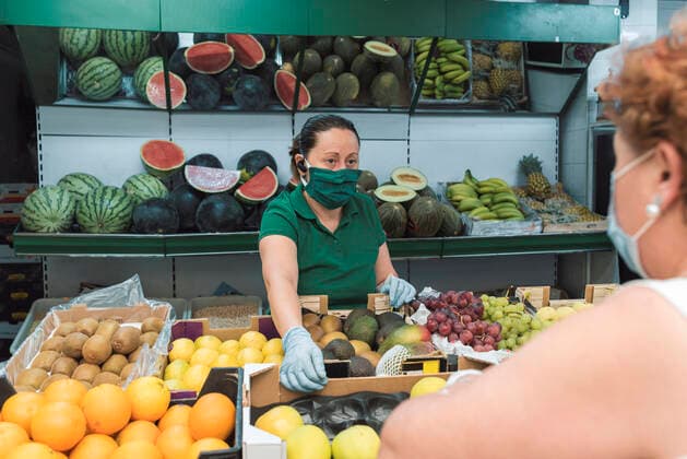 a shopkeeper with a mask attends to a customer in the greengrocer s. Torredelcampo, AL, Spain CR_NNSU200920A-508742-01 ,model released, Symbolfoto ,property released