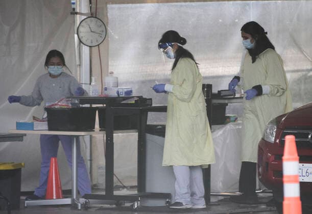 (200924) -- VANCOUVER, Sept. 24, 2020 -- Healthcare workers work inside a COVID-19 testing center in Vancouver, British Columbia, Canada, Sept. 24, 2020. Canadian Prime Minister Justin Trudeau said Wednesday evening that the second wave of COVID-19 epidemic has already begun in the country amid concerns over a possible national lockdown. COVID-19 cases have jumped nationally in Canada, from about 300 cases per day in mid-August to 1,248 on Tuesday. (Photo by Xinhua) CANADA-VANCOUVBER-COVID-19-SECOND WAVE LiangxSen 