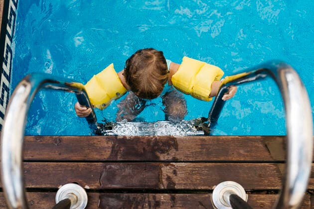 Little girl on ladder of pool model released Symbolfoto property released JRFF04698