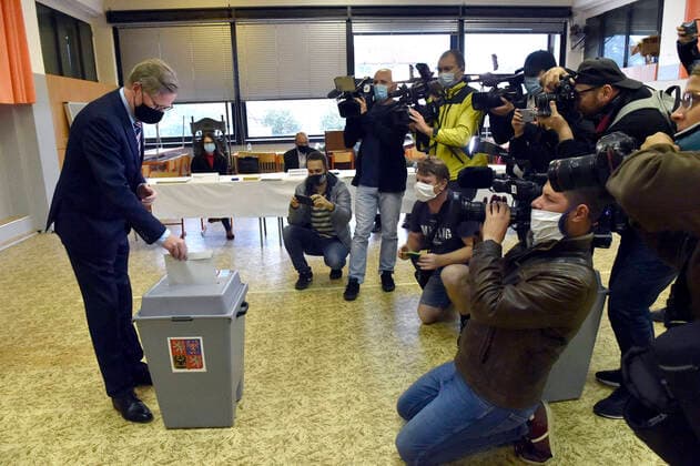 Chairman ODS Petr Fiala, left, wearing a protective mask casts his ballot during the regional and Senate elections in Brno, Czech Republic, October 2, 2020. (CTKxPhoto VaclavxSalek) CTKPhotoP202010020780201 sal 02