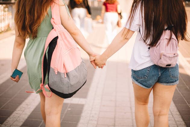 Creative Highlights Symbolfotos Back view of lesbian couple holding hands while walking in city CR_DMBE200923-468778-01 ,model released, Symbolfoto