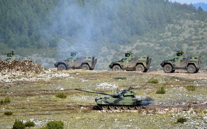 (201011) -- PESTER, Oct. 11, 2020 -- Serbian armored vehicles perform a task during a military exercise at the Pester plateau in southwestern Serbia on Oct. 10, 2020. The Serbian army held a large live-fire tactical exercise on Saturday with a focus on close air support. The exercise demonstrated a joint action of about 2,800 members of the Air Force, the Army, the 72nd Special Operations Brigade, and the 63rd Parachute Brigade, more than 150 combat and non-combat vehicles and combat systems, as well as about 40 aircraft. (Photo by Xinhua) SERBIA-PESTER-MILITARY-EXERCISE PredragxMilosavljevic 