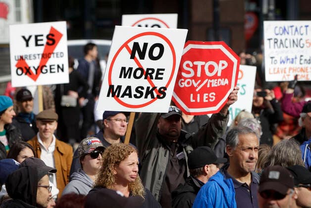 (201017) -- VANCOUVER, Oct. 17, 2020 -- Protesters hold signs during an anti-restriction rally in Vancouver, British Columbia, Canada, on Oct. 17, 2020. Thousands of protesters took part in the anti-coronavirus-restriction rally to express their disapproval over a number of topics including lockdowns, mask mandates, quarantine, travel bans and social distancing. (Photo by Xinhua) CANADA-VANCOUVER-COVID-19-ANTI-RESTRICTION PROTEST LiangxSen 