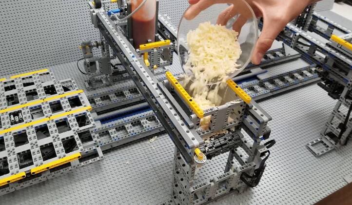 A Lego fan has built a jaw-dropping pizza-making machine entirely from Lego. Canada-based Iouri Petoukhov works with his son Michael to make amazing creations under the name The Brick Wall. Now they have celebrated five years of their projects with an intricate machine that serves up perfect pizzas. It includes mechanisms that dispense tomato sauce, grated cheese, sausage and peppers all while the pizza base revolves to allow even covering of toppings. Iouro tells Cover Images: We have family time when all speak out about what we called crazy ideas and then we write them down on paper and put it on our Brick wall. Making Pizza is an art and love, making Pizza wit Copyright: xx 40952510 EDITORIAL USE ONLY. NOT FOR USE BY NEWSPAPERS BASED IN THE UK.