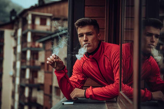 Creative Highlights Symbolfotos Young men smoking while looking out of window model released Symbolfoto ACPF00814