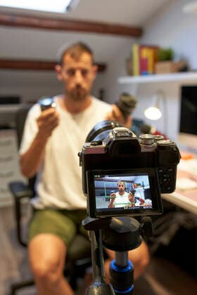 Mid adult man video recording from home model released Symbolfoto property released VEGF02957