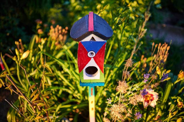 Austria - June 29, 2019: Buntes Vogelhäuschen im Blumengarten. Burgenland Austria *** Austria June 29, 2019 Colourful bird house in the flower garden Burgenland Austria 