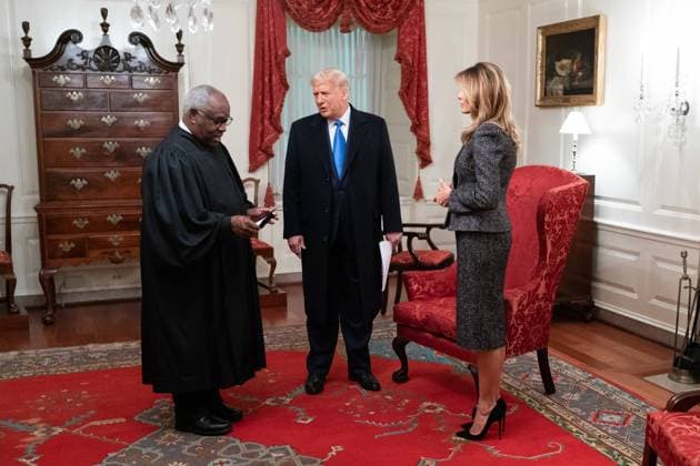 October 26, 2020, Washington, The District of Columbia, United States Of America: President Donald J. Trump and First Lady Melania Trump talk with Supreme Court Associate Justice Clarence Thomas in the Map Room of the White House Monday, Oct. 26, 2020, before attending the swearing-in ceremony of Judge Amy Coney Barrett as a Supreme Court Associate Justice...People: President Donald J. Trump and First Lady Melania Trump, Supreme Court Associate Justice Clarence Thomas. Washington United States Of America - ZUMAs214 20201026_zaa_s214_021 Copyright: xSMGx