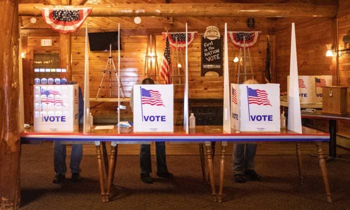 November 3, 2020, Log Haven Restaurant and Lounge, Millsfield, New Hampshire USA: Residents of Millsfield New Hampshire writing their ballots during midnight voting at Log Haven Restaurant and Lounge in Millsfield. President Donald Trump and Vice President Mike Pence received sixteen votes and Democratic presidential candidate and former Vice President Joe Biden received five votes just after midnight.  (147552165)