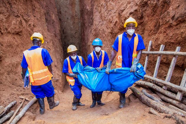(201113) -- GATSIBO, Nov. 13, 2020 -- Volunteers carry remains of victims of the 1994 Rwandan genocide in a mass grave in Kiziguro sector, Gatsibo District, eastern Rwanda, Nov. 12, 2020. Local authorities, residents and Ibuka, an umbrella organization of genocide survivors associations, are jointly exhuming a mass grave believed to contain remains of about 5,000 victims of the 1994 Rwandan genocide in Gatsibo District, eastern Rwanda, a local official said. (Photo by Xinhua) RWANDA-GATSIBO-MASS GRAVE-GENOCIDE CyrilxNdegeya 