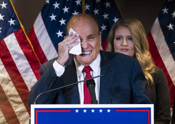 Rudy Giuliani, President Donald Trump s campaign legal advisor, wipes sweat from his face as he speaks on the election results, at the Republican National Committee headquarters in Washington, DC on Thursday, November 19, 2020.  WAP20201119302 KEVINxDIETSCH