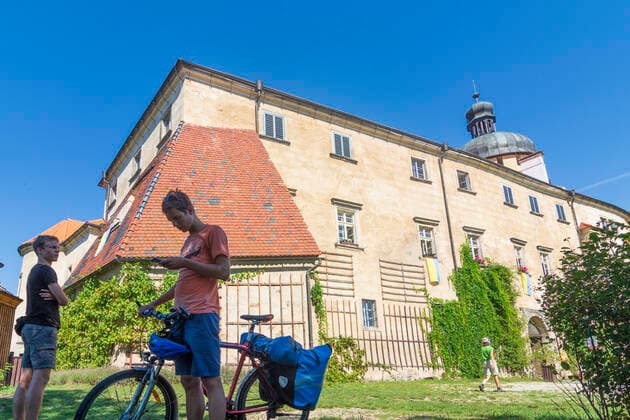 Grabstejn (Grafenstein) Castle, cyclist, young man checks route on the smartphone Hradek nad Nisou (Grottau) Liberecky, Liberec Region, Reic Czech