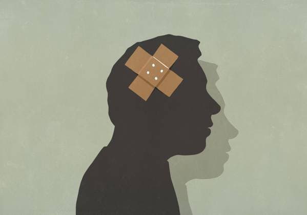Adhesive bandage over silhouette of mans brain  Copyright: MaltexMueller fStopImages1944053