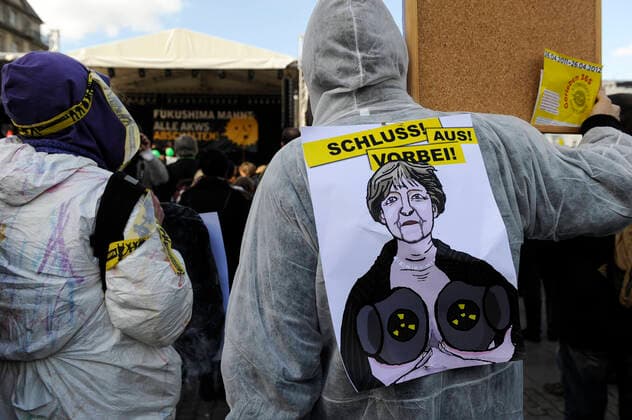 Hamburg DEMO gegen Atomkraft GERMANY Hamburg, big rally against nuclear power after Fukushima accident in Japan *** DEUTSCHLAND, Hamburg, DEMO fuer Atomausstieg nach Havarie im AKW Fukushima in Japan, Plakat mit Bild der Bundeskanzlerin Angela Merkel Hamburg Germany