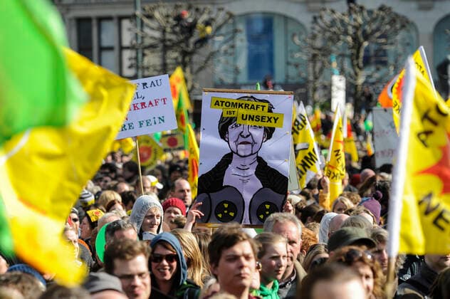 Hamburg DEMO gegen Atomkraft GERMANY Hamburg, big rally against nuclear power after Fukushima accident in Japan *** DEUTSCHLAND, Hamburg, DEMO fuer Atomausstieg nach Havarie im AKW Fukushima in Japan, Plakat mit Bild der Bundeskanzlerin Angela Merkel mit Schriftzug Atomkraft ist unsexy Hamburg Germany