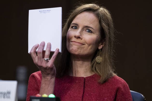 Supreme Court nominee Judge Amy Coney Barrett holds up a blank note pad on the second day of her confirmation hearing before the Senate Judiciary Committee, on Capitol Hill in Washington DC, on Tuesday, October 13, 2020. If confirmed, Barrett will replace Justice Ruth Bader Ginsburg, who died last month. Pool photo by Tom Williams  POY2020DC183 TOMxWILLIAMS