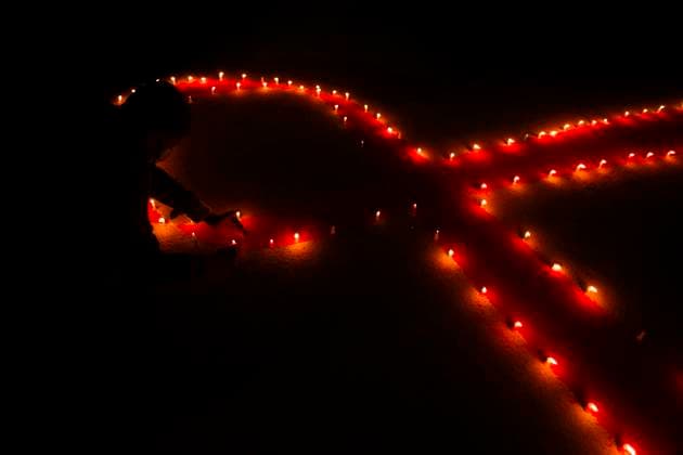 November 30, 2020, Kathmandu, Nepal: People from Maiti Nepal a rehabilitation center for victims of trafficking and home for the HIV affected, light candles around a red ribbon on the eve of World AIDS Day in Kathmandu, Nepal on Monday, November 30, 2020. World AIDS Day is observed every year on December 1st to raise awareness and support to those living with HIV. Kathmandu Nepal - ZUMAg200 20201130_zap_g200_001 Copyright: xSkandaxGautamx