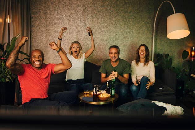 Heterosexual couples cheering while watching sports together at night, MA82822, Sweden, Stockholm, model released, property released Copyright: xMaskotx