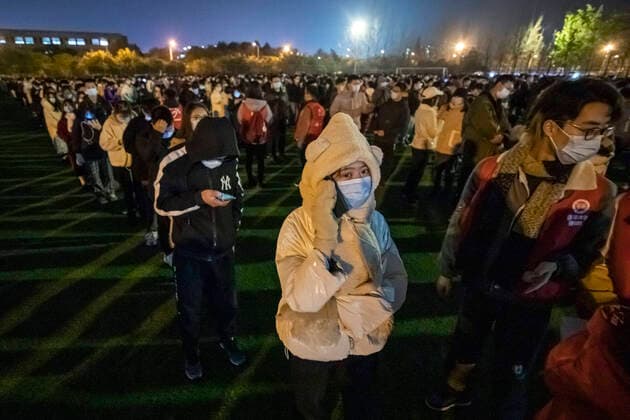 (201212) -- BEIJING, Dec. 12, 2020 -- Students wait in lines for nucleic acid tests at the Xihua University in Pidu District of Chengdu, southwest China s Sichuan Province, Dec. 11, 2020. Southwest China s Chengdu launched a nucleic acid testing drive Friday, offering free tests to all residents in the city s Pidu District, where several new COVID-19 cases have emerged since earlier this week. The district s COVID-19 prevention and control headquarters said the drive started at 6 p.m., with testing expenses covered by the district government. ) XINHUA PHOTOS OF THE DAY ShenxBohan 