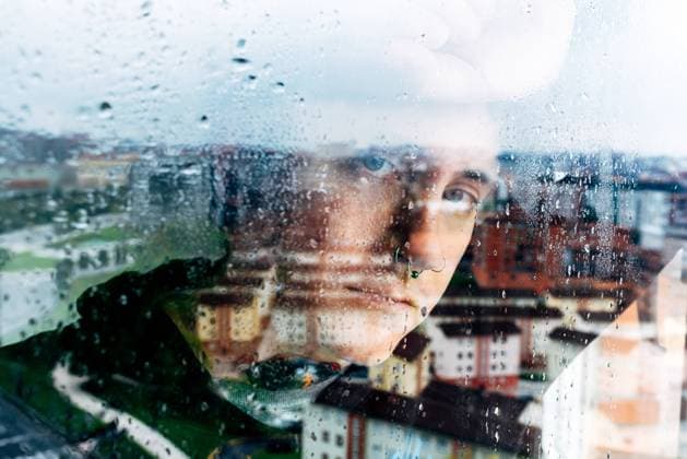 Depressed man looking through window Copyright: xAlbertoxMenendezx Model Released