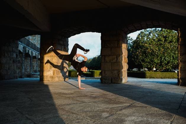 Unrecognizable teenager break dancing in arch, Model released Copyright: xAlbertoxMenendezx MR