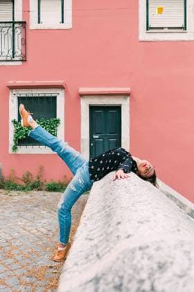 Young slim casual woman stretching on street of old city while dancing gracefully, Model released Copyright: xAlexandraxCoelhox MR