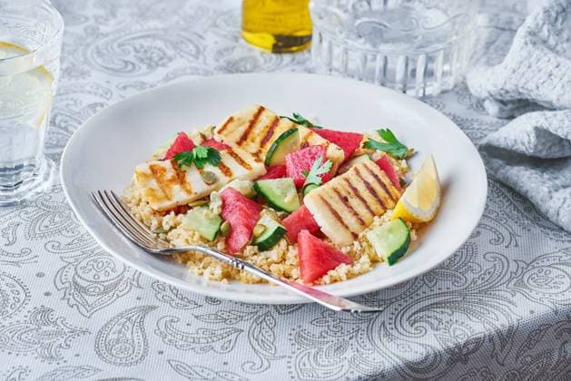 Appetizing Bulgur salad with watermelon and cucumbers in plate served on table for tasty lunch Copyright: xAnaxGomezx Model Released