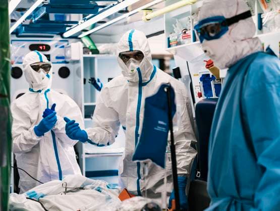 Group of professional doctors in protective uniform standing in ambulance car with equipment and preparing for patient transportation, Model released Copyright: xAparicioxFebrerx MR