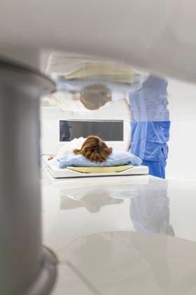 Middle-aged woman and her doctor in an open MRI machine waiting for the test to start, Model released Copyright: xDavidxFuentesx MR