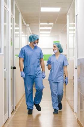 fellow surgeons man and woman chat while walking towards the operating theater, Model released Copyright: xDavidxFuentesx MR