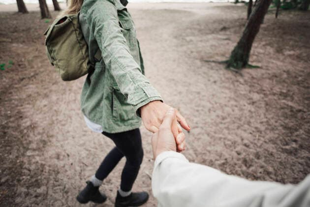 Low section of woman holding man s hand in forest , model released Copyright: xMaskotx , MA47628