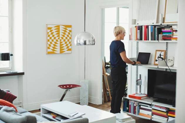 Rear view of product designer using laptop at shelf in home , model released, property released Copyright: xMaskotx , MA47852