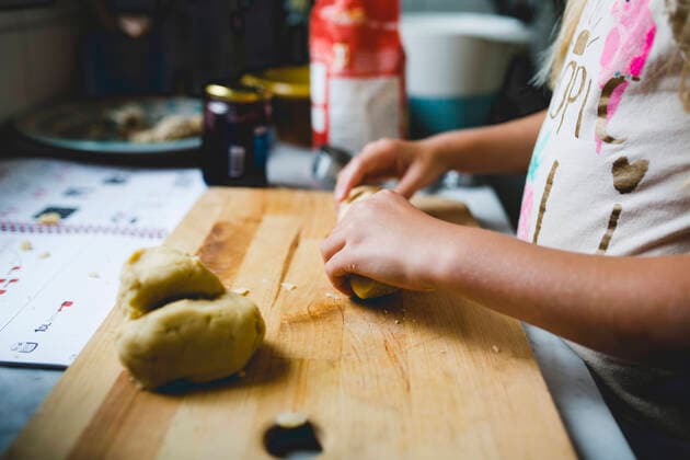 Girl preparing dough on cutting board at kitchen counter , model released Copyright: xMaskotx , MA48701