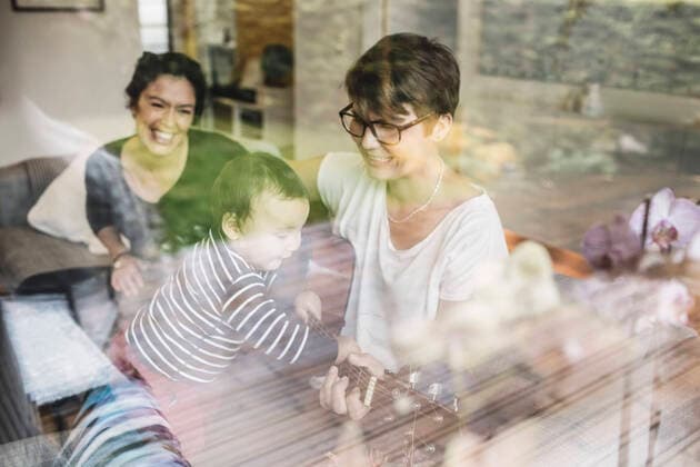 Smiling family enjoying music seen through glass window , model released Copyright: xMaskotx , MA49069