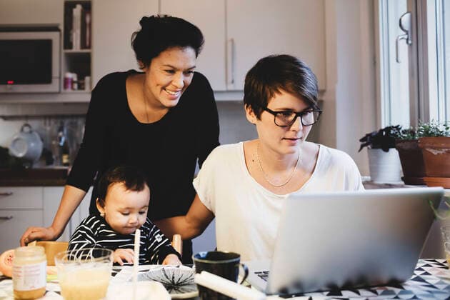 Women looking in laptop while baby girl having food at table , model released Copyright: xMaskotx , MA49080
