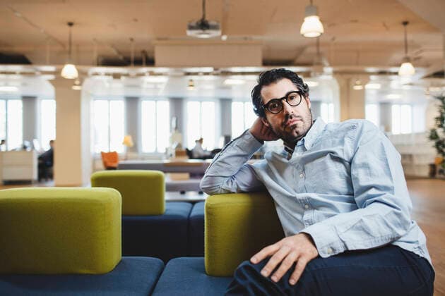 Portrait of mature man sitting on couch at corridor , model released Copyright: xMaskotx , MA49349