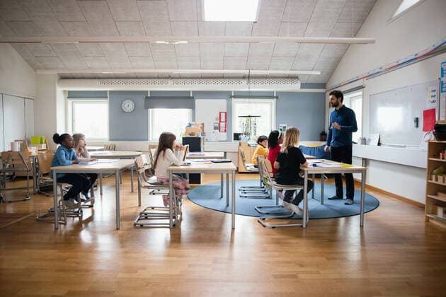 Teacher teaching students in brightly lit classroom at school , model released, property released Copyright: xMaskotx , MA51289