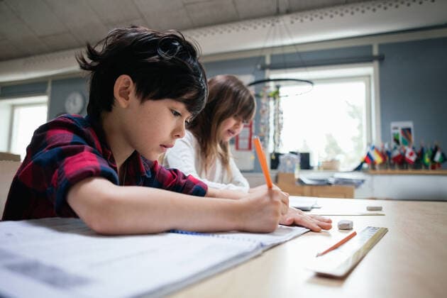 IMAGO Creative: Bildung, Schreiben Serious students studying at desk in classroom , model released, property released Copyright: xMaskotx , MA51327