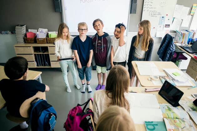 High angle view of students giving presentation with digital tablet in classroom , model released, property released Copyright: xMaskotx , MA52018