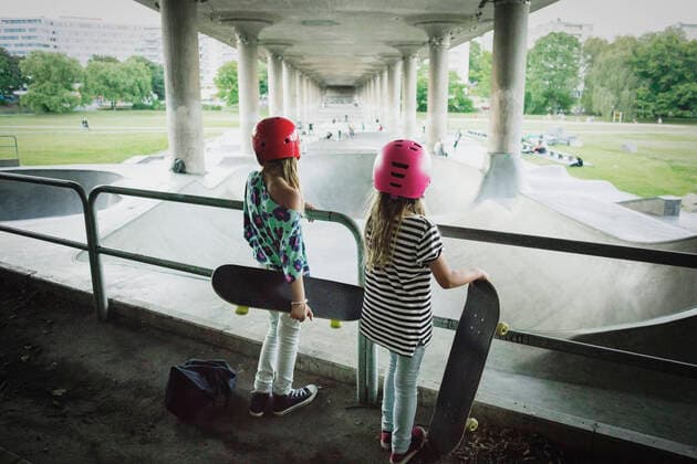 Rear view of friends looking at skateboard park while standing by railing , model released Copyright: xMaskotx , MA53691