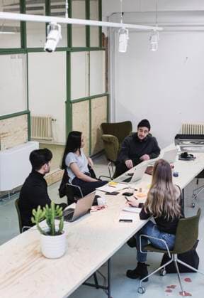 High angle view of four entrepreneurs discussing at desk in creative office , model released, property released Copyright: xMaskotx , MA54530