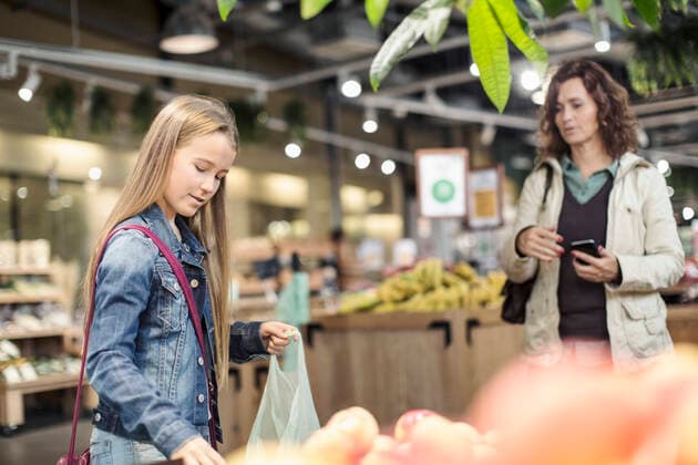 Mother looking at daughter buying apples in supermarket , model released, property released Copyright: xKentarooxTrymanx , MA54885