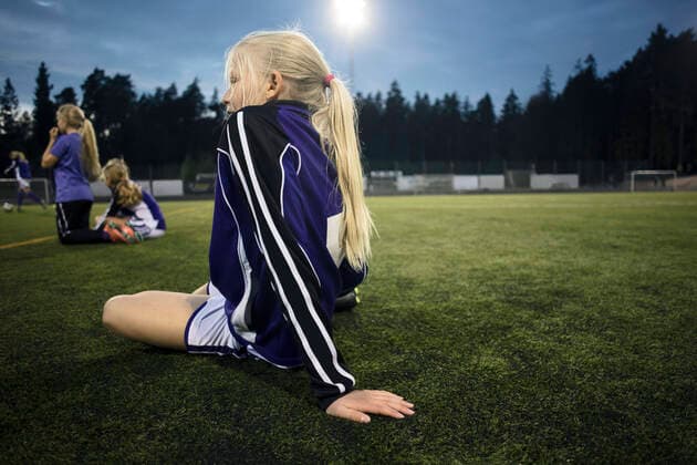 Side view of girl sitting on field against sky , model released Copyright: xMaskotx , MA55672