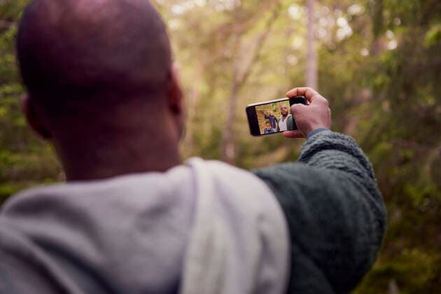 Man taking selfie with family in forest , model released Copyright: xMaskotx , MA57741