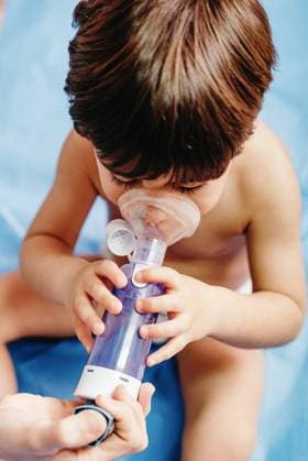 Sick boy getting inhalation treatment in clinic Copyright: xGustavoxPozox Model Released