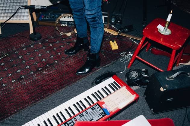 Low section of female musician standing by instruments on floor at studio , model released, property released Copyright: xMaskotx , MA62196