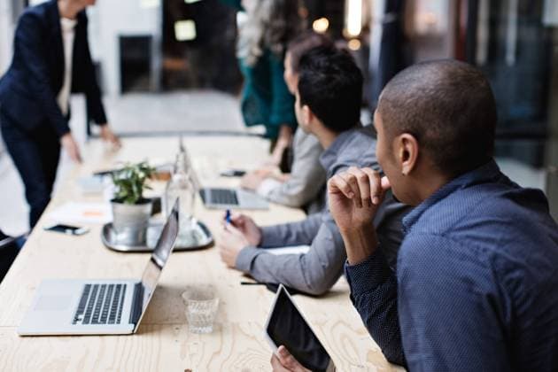 Business colleagues listening while sitting at table during meeting , model released, property released Copyright: xMaskotx , MA62973