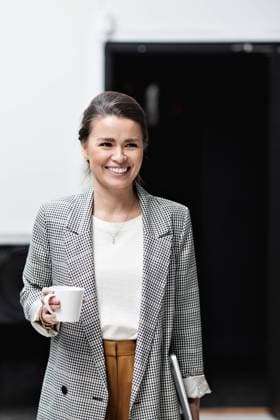 Portrait of smiling businesswoman looking away while holding coffee cup at office , model released, property released Copyright: xMaskotx , MA63002